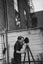 filming, two watching from window