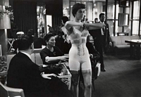 model with hands pressed together wearing corset