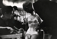 model seated wearing corset