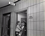 Congressman and baby emerging from men's room